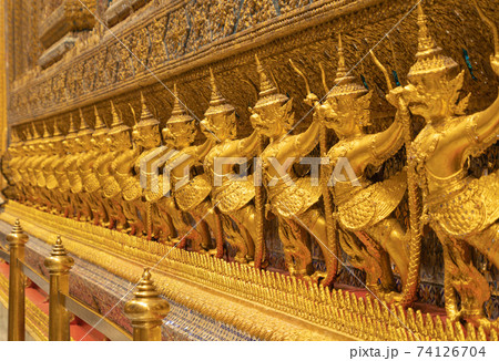 Garuda statue at Golden pagoda at Temple of the Emerald Buddha in Bangkok, Thailand. Wat Phra Kaew and Grand palace in old town, urban city. Buddhist temple, Thai architecture. Garuda statue at Golden pagoda at Temple of the Emerald Buddha in Bangkok, Thailand. Wat Phra Kaew and Grand palace in old town, urban city. Buddhist temple, Thai architecture. 74126704