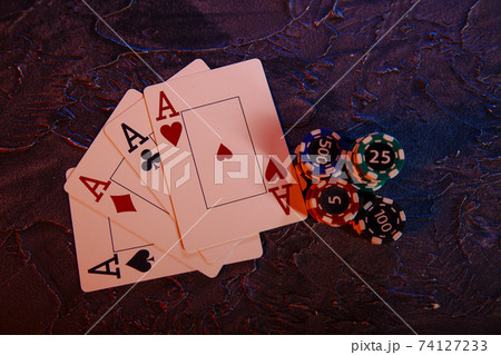 Online gambling сoncept. Aces and chips on a grey background Online gambling сoncept. Aces and chips on a grey background 74127233