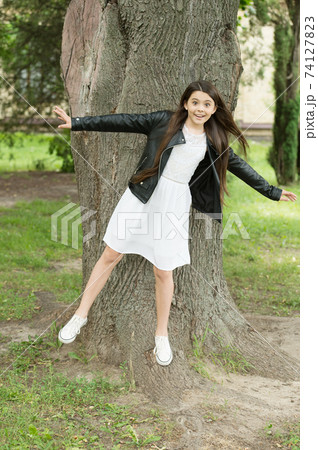 Hipster girl relaxing park tree trunk crust background, having fun concept Hipster girl relaxing park tree trunk crust background, having fun concept 74127823