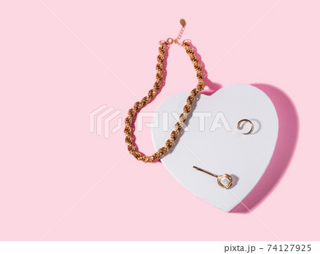 Fashion valentine backgound with golden accessories on white heart shape podium Fashion valentine backgound with golden accessories on white heart shape podium 74127925
