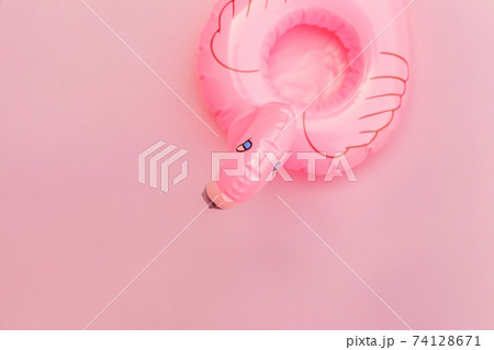 Summer beach composition. Simply minimal design with Inflatable flamingo isolated on pastel pink background. Pool float party, trendy celebrity fashion concept. Flat lay top view copy space. Summer beach composition. Simply minimal design with Inflatable flamingo isolated on pastel pink background. Pool float party, trendy celebrity fashion concept. Flat lay top view copy space. 74128671