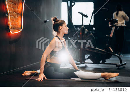 Fitness woman stretching doing pilates stretches exercises 74128819