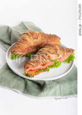 Croissant Sandwich with salmon and salad leaves Croissant Sandwich with salmon and salad leaves 74129185