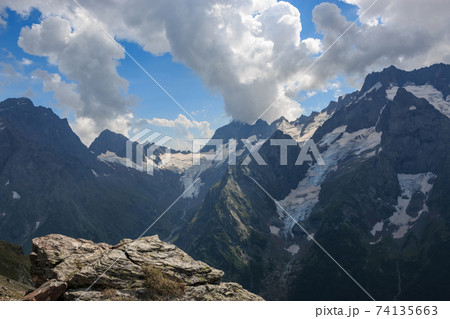 Panorama of mountains scene with dramatic blue sky in national park of Dombay 74135663