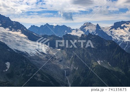 Panorama of mountains scene with dramatic blue sky in national park of Dombay Panorama of mountains scene with dramatic blue sky in national park of Dombay 74135675