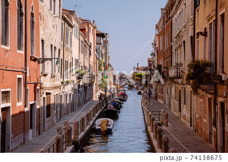 Panoramic view of Venice narrow canal with historical buildings and boat 74138675