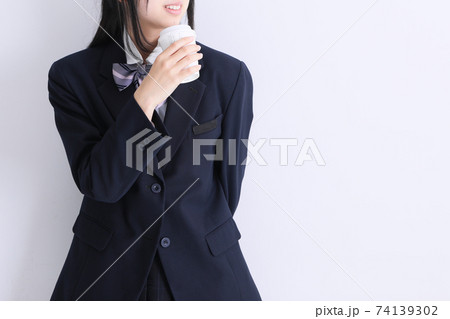 Japan 女子高校生がコーヒーを飲んで笑顔で笑っているの写真素材