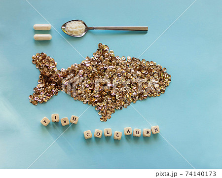 Fish collagen capsules and powder on trendy blue background. Fish collagen capsules and powder on trendy blue background. 74140173