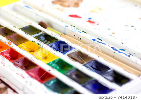 Set of professional watercolor paints and paintbrush for painting closeup. Selective focus. 74140187