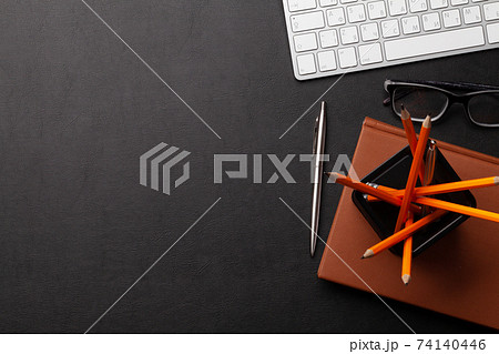 Office desk with supplies and glasses Office desk with supplies and glasses 74140446