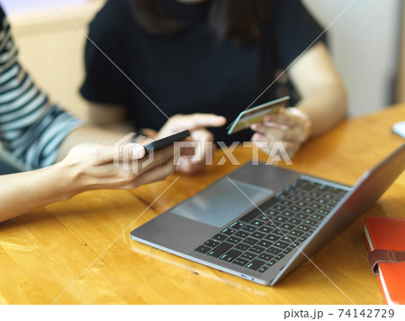 Businesspeople hands online banking with smartphone and credit card Businesspeople hands online banking with smartphone and credit card 74142729