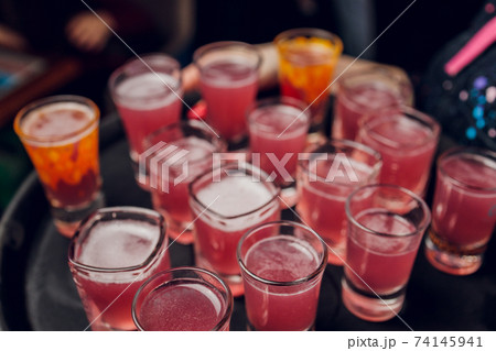 Variation of hard alcoholic shots served on bar counter. Blur bottles on background. Variation of hard alcoholic shots served on bar counter. Blur bottles on background. 74145941