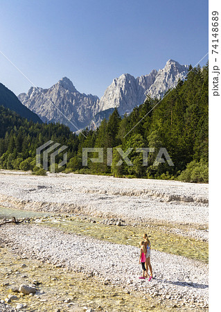 Children by the river near village Kranjska Gora in Triglav national park, Slovenia 74148689
