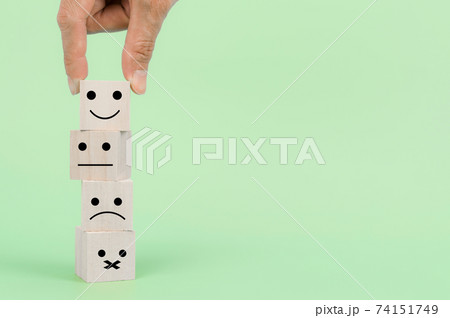 Customer hand choose a happy face. Service, communication, Feedback concept Customer hand choose a happy face. Service, communication, Feedback concept 74151749