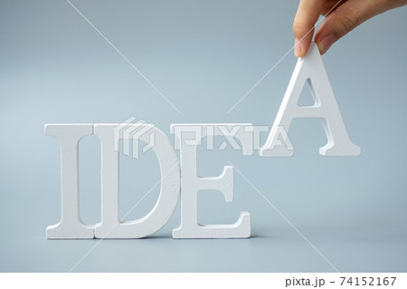 Businessman hand holding wooden IDEAS text on gray background. New Creative, Innovation, Imagination, inspiration, Solution, Strategy and GOAL concept Businessman hand holding wooden IDEAS text on gray background. New Creative, Innovation, Imagination, inspiration, Solution, Strategy and GOAL concept 74152167
