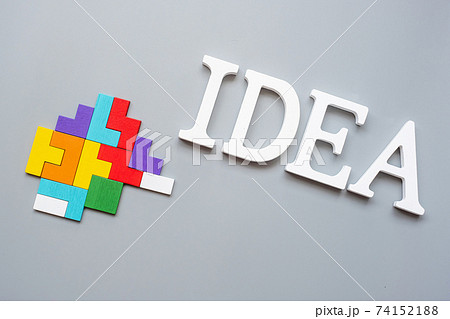 IDEA text with colorful wood puzzle pieces on gray background. logical thinking, business logic, Conundrum, inspiration, solutions, rational, mission, success, goals and strategy concepts 74152188