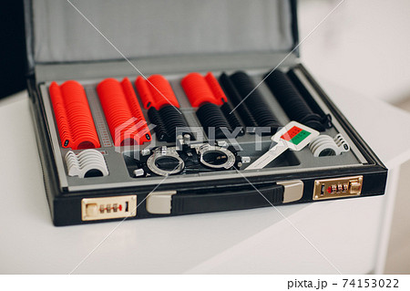 Opthalmology test box. The universal messbrille tool of the optometrist and oculist. Set of dioptric glasses in optician salon. Opthalmology test box. The universal messbrille tool of the optometrist and oculist. Set of dioptric glasses in optician salon. 74153022