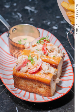Lobster Roll.fresh Maine Lobster boiled, mixed with mayo, celery, chives served in toasted hero roll with crisp lettuce and drawn butter. Lobster Roll.fresh Maine Lobster boiled, mixed with mayo, celery, chives served in toasted hero roll with crisp lettuce and drawn butter. 74155770