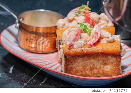 Lobster Roll.fresh Maine Lobster boiled, mixed with mayo, celery, chives served in toasted hero roll with crisp lettuce and drawn butter. 74155775