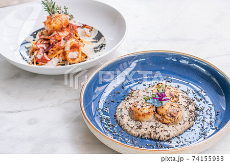 Seared scallop appetizer in dish 74155933