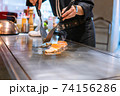 Hand of Chef cooking salmon steak 74156286