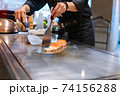Hand of Chef cooking salmon steak 74156288