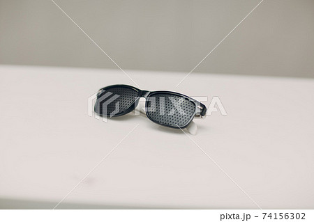 Black punched eyeglasses for vision training. perforated glasses trainer 74156302