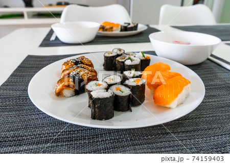Fresh sushi and rolls in a white plate. Sushi lunch Fresh sushi and rolls in a white plate. Sushi lunch 74159403