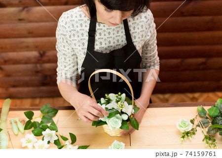 Girl works in a flower shop, top view Girl works in a flower shop, top view 74159761