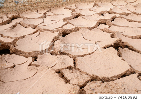 Mudlands that previously contained water have cracked due to hot weather and drought. All water content has been evaporated by the heat 74160892