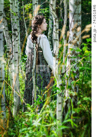 Girl in an ethnic costume got lost in a forest Girl in an ethnic costume got lost in a forest 74161846