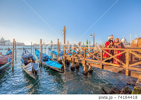 Colorful carnival masks at a traditional festival in Venice, Italy 74164418