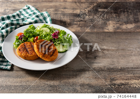 Delicious healthy chickpea burger and salad 74164448