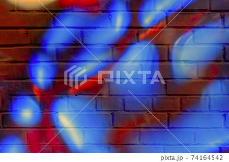 Brick wall decorated with bright rounded spots. Detail of a graffiti. Modern stylish background. Brick wall decorated with bright rounded spots. Detail of a graffiti. Modern stylish background. 74164542