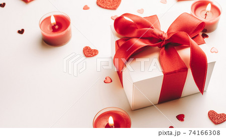 Valentines day heart, romantic gift box, red love candle on white background. Sainte Valentine, mothers day, birthday greeting cards, invitation, celebration concept. 74166308