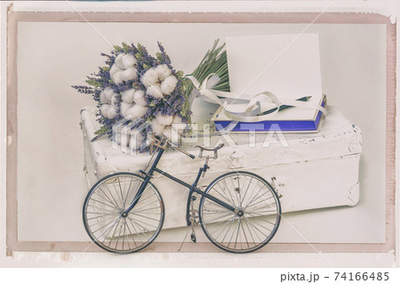 Lavender flowers and Cotton plant on old white suitcase, Mini bike, personal notebook. Vintage postcard style Lavender flowers and Cotton plant on old white suitcase, Mini bike, personal notebook. Vintage postcard style 74166485