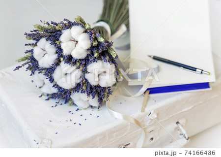 Lavender flowers and Cotton plant on vintage suitcase, open card for text. Natural Romantic eco gift Lavender flowers and Cotton plant on vintage suitcase, open card for text. Natural Romantic eco gift 74166486