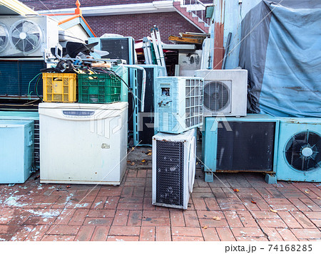 old air conditioners and refrigerators on street