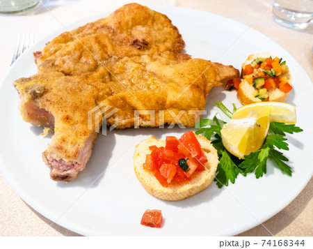 Italian cuisine - Cotoletta alla Milanese close up 74168344