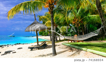 Relaxing tropical holidays with beach chairs and hammock. Mauritius island 74168934