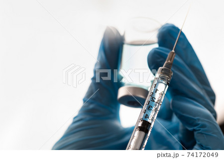 Doctor or Nurse Wearing Surgical Gloves Holding Vaccine Vial and Medical Syringe Doctor or Nurse Wearing Surgical Gloves Holding Vaccine Vial and Medical Syringe 74172049