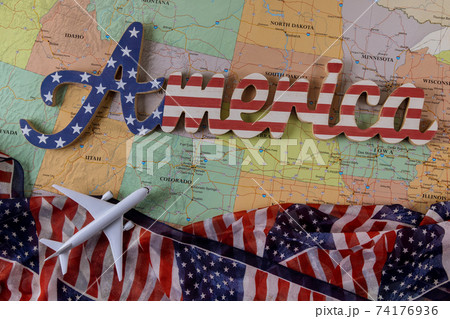 Concept travelling for vacation in the Beautiful USA country with air plane model and US flag on American map Concept travelling for vacation in the Beautiful USA country with air plane model and US flag on American map 74176936
