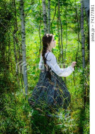 Girl in an ethnic costume got lost in a forest Girl in an ethnic costume got lost in a forest 74177861