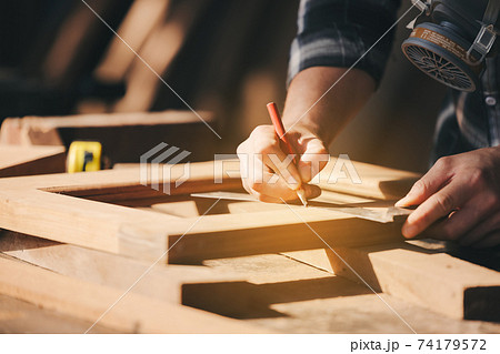 Confident wood worker expert. Young man working at factory. Skilled carpenter Confident wood worker expert. Young man working at factory. Skilled carpenter 74179572