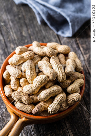 Roasted peanuts. Tasty groundnuts in pot. Roasted peanuts. Tasty groundnuts in pot. 74183503