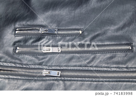 Detail of the metal zippers of the classic black leather jacket. Fashion concept 74183998