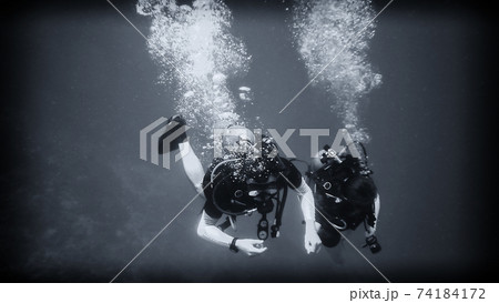 Above the abyss, a diver under water 74184172