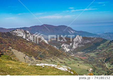 French countryside. Pas de l'Aubasse: View of the heights of the Vercors, the marly hills and the valley Val de Drome 74186152