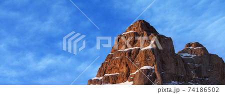 Top of high rocky mountain with snow at beautiful sunrise Top of high rocky mountain with snow at beautiful sunrise 74186502