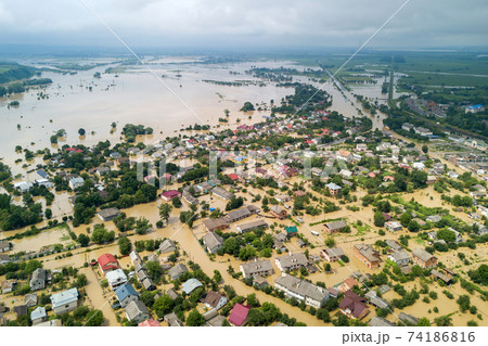 Aerial view of flooded houses with dirty water of Dnister river in Halych town, western Ukraine. Aerial view of flooded houses with dirty water of Dnister river in Halych town, western Ukraine. 74186816